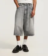 Bermuda de jean para hombre, modelo super baggy, con lavado dirty y cinturón de lazo en la cintura.