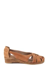 Sandalias de cuero marrón claro con cuña revestida en yute trenzado, diseño superior de tiras cruzadas y detalles texturizados.