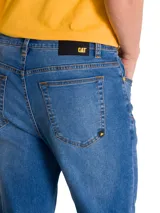 Pantalón de jean azul con corte clásico y acabado stretch, confeccionado en mezcla de algodón y poliéster con spandex para mayor flexibilidad. Cuenta con diseño de cinco bolsillos y costuras reforzadas.