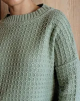 Sweater de punto color verde claro con textura tipo waffle, cuello redondo y mangas 3/4.