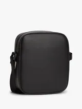 Bandolera reporter de poliuretano negro, con cierre de cremallera, correa ajustable y parche con el logo de Tommy Jeans en la parte delantera.