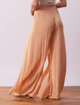 Pantalón Sound Style color naranja de gasa bambula con pretina ancha elastizada en la espalda y tajos en el frente.