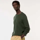 Sweater de punto con textura fantasía, cuello redondo y mangas largas con puños acanalados.
