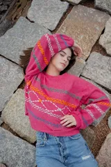 Sweater fucsia de hilado semi metálico con bordados y mangas oversized. Diseño con patrón de bordados.