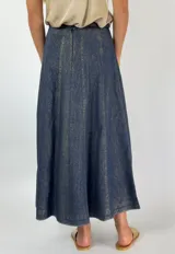 Pollera midi de jean color azul oscuro con pespuntes dorados y corte acampanado.