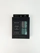 Pack de dos boxers ajustados marca Rusty, uno en gris oscuro liso y otro en verde oscuro con detalles en blanco en la banda elástica.