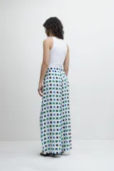 Pantalón de corte ancho con estampa geométrica de cuadrados azules, verdes y blancos.