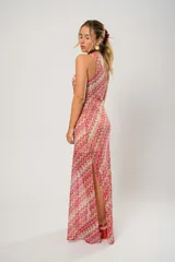 Vestido midi de crochet con diseño de ondas en tonos rojo, rosa y beige. Tiene un solo hombro y tajos laterales.