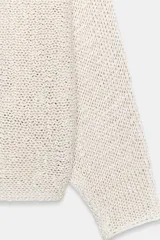 Jersey de punto con cuello barco y mangas anchas de corte holgado.