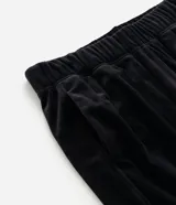 Pantalón jogger de plush color negro, con cintura elástica, bolsillos laterales y puños ajustados en los tobillos.