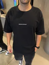 Remera de algodón pesado con corte oversize y diseño estampado en la espalda con tipografía blanca y un círculo de trazo artístico.