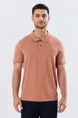 Remera polo de manga corta en color azul melange, con cuello camisero, cierre frontal de dos botones y pequeño bordado en el pecho.