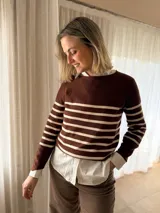 Sweater de tejido de punto con diseño de rayas horizontales en color marrón y crema, con escote redondo a la base y mangas largas.