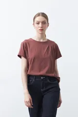 Remera básica de manga corta en color blanco, con cuello redondo y detalle de pliegues sutiles en los hombros.