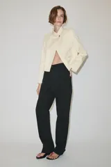 Jeans de tiro medio color negro, de corte recto y largo completo, con diseño clásico de cinco bolsillos, trabillas para cinto y cierre frontal con cremallera y botón.