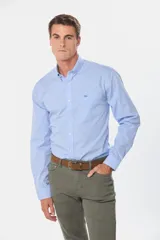Camisa celeste con estampado a cuadros, de manga larga, con cuello abotonado, bolsillo en el pecho y logo bordado.