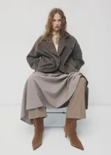 Botin de gamuza color marrón con taco fino y punta afilada, diseñado con un estilo elegante y minimalista.