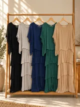 Vestido largo color beige de seda italiana, con falda de volados y sobrecapa superior. Confeccionado en tejido liviano y fluido con diseño elastizado.