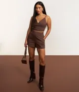 Short lila de tejido bengaline, con bolsillos delanteros y cremallera lateral.