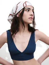 Pañuelo de seda blanco con estampado de líneas curvas en color verde lima, y texto sutil en la tela.