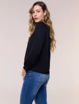 Blusa de modal y elastano color blanco, de silueta holgada, escote redondo amplio con elástico interno fruncido y mangas largas fluidas con puños ajustados.