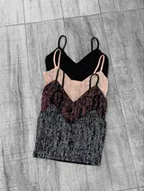 Top de breteles finos con escote en V, confeccionado en lurex con textura brillante.