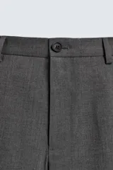 Pantalón de vestir regular fit color negro, confeccionado en tejido con mezcla de lana y elasticidad. Cuenta con cintura elástica, bolsillos frontales, bolsillos traseros de vivo con botón, y cierre frontal con cremallera y botón.