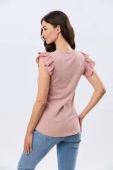 Remera de algodón color beige, de manga corta con volados de broderie, escote redondo y cuerpo liso.