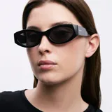 Lentes de sol negros con montura ovalada de acetato y lentes polarizadas alemanas con protección UV400.
