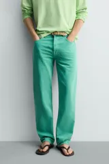 Jeans de mezclilla de corte recto, tiro medio, color verde vibrante con efecto lavado. Presenta cierre frontal con cremallera y botón, y cinco bolsillos.