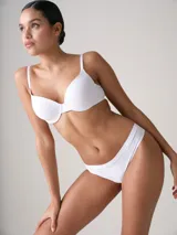 Bombacha colaless de tiro bajo y diseño invisible con corte láser en tono beige.