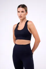 Top deportivo negro con breteles anchos y espalda deportiva.