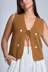Chaleco tejido color verde oliva, con bordado de flores blancas y naranjas.