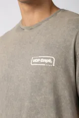Remera de algodón peinado con efecto de lavado snow que le otorga un aspecto gastado. Presenta un diseño de cuello redondo, mangas cortas y un pequeño estampado gráfico en el pecho.