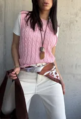 Chaleco tejido de punto color rosa con diseño de trenzas.