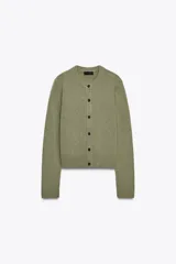Chaqueta de tejido de punto color verde musgo, de corte cropped, con cuello redondo y cierre frontal de botones oscuros.