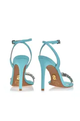 Sandalias de fiesta color amarillo flúor con taco aguja alto, tira delantera con apliques de strass y pulsera al tobillo con hebilla.