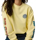 Buzo Rip Curl de fleece, modelo Sg Heritage Oversized, color amarillo, con cuello redondo y diseño holgado. Presenta un pequeño estampado circular en el pecho y letras estampadas en la manga.