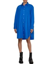 Vestido camisero de corte oversize confeccionado en algodón orgánico. Presenta cuello inglés, cierre frontal de botones, mangas largas con puños abotonados y largo hasta la rodilla. Incluye el logo de la marca bordado en uno de los puños.