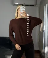 Sweater de punto con cuello redondo y mangas largas, con diseño de textura acanalada en los laterales y mangas. Presenta un corte holgado y cómodo.