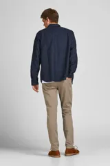 Pantalón chino color beige con cierre de cremallera.