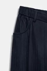 Pantalón de tiro medio confeccionado en mezcla de lyocell, con diseño de pierna ancha y tejido en espiga. Cuenta con cintura elástica ajustable con cordones y bolsillos laterales.