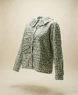 Camisa de algodón con estampado a cuadros en tonos grisáceos. Presenta un cuello amplio con volados, detalles fruncidos en el frente, cierre frontal con botones y mangas largas con puños abotonados.