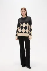 Sweater de tejido jacquard con diseño de rombos en colores azul marino y rojo, de corte holgado, manga larga y cuello redondo.