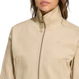 Campera corta Adidas Firebird color beige con cierre frontal y cuello alto. Presenta las tres líneas características de la marca en las mangas.