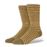 Medias Stance modelo Skipper Stone, con diseño de rayas horizontales en tonos verde oliva y mostaza, puntera y talón reforzados en color marrón con una línea celeste.