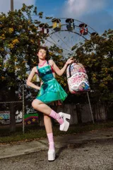 Mochila Sprayground con estampado de graffiti multicolor y diseño de boca de tiburón con dientes blancos. Cuenta con bolsillo frontal con cremallera, bolsillos laterales, bolsillo oculto con cremallera, compartimento para gafas de sol, acolchado ergonómico en la parte posterior, correas ajustables, cierres dorados, placa metálica con logo, compartimento para laptop y espalda ergonómica con malla.