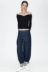 Jeans de tiro medio con diseño de pierna tipo balloon y corte full length. Presenta cintura con trabillas, cinco bolsillos clásicos, cierre frontal con cremallera y botón, y bajo acabado con vuelta.