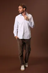 Camisa blanca de manga larga con cuello clásico y cierre frontal con botones.