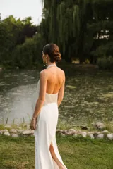 Vestido largo de novia color blanco, con cuerpo superior estilo halter de lentejuelas brillantes y falda larga fluida y ajustada.